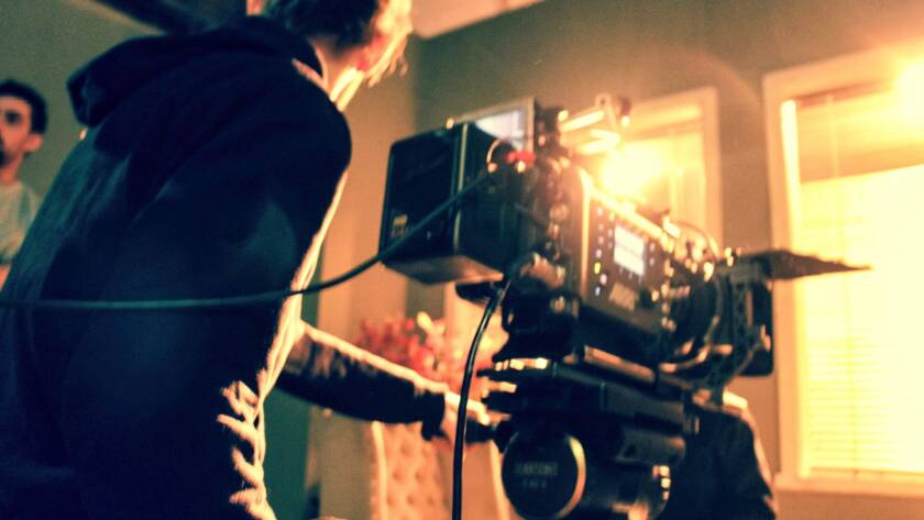 Cameraman holding a camera. Camera crew. Film camera. Digital Camera. Making film. Tv production.